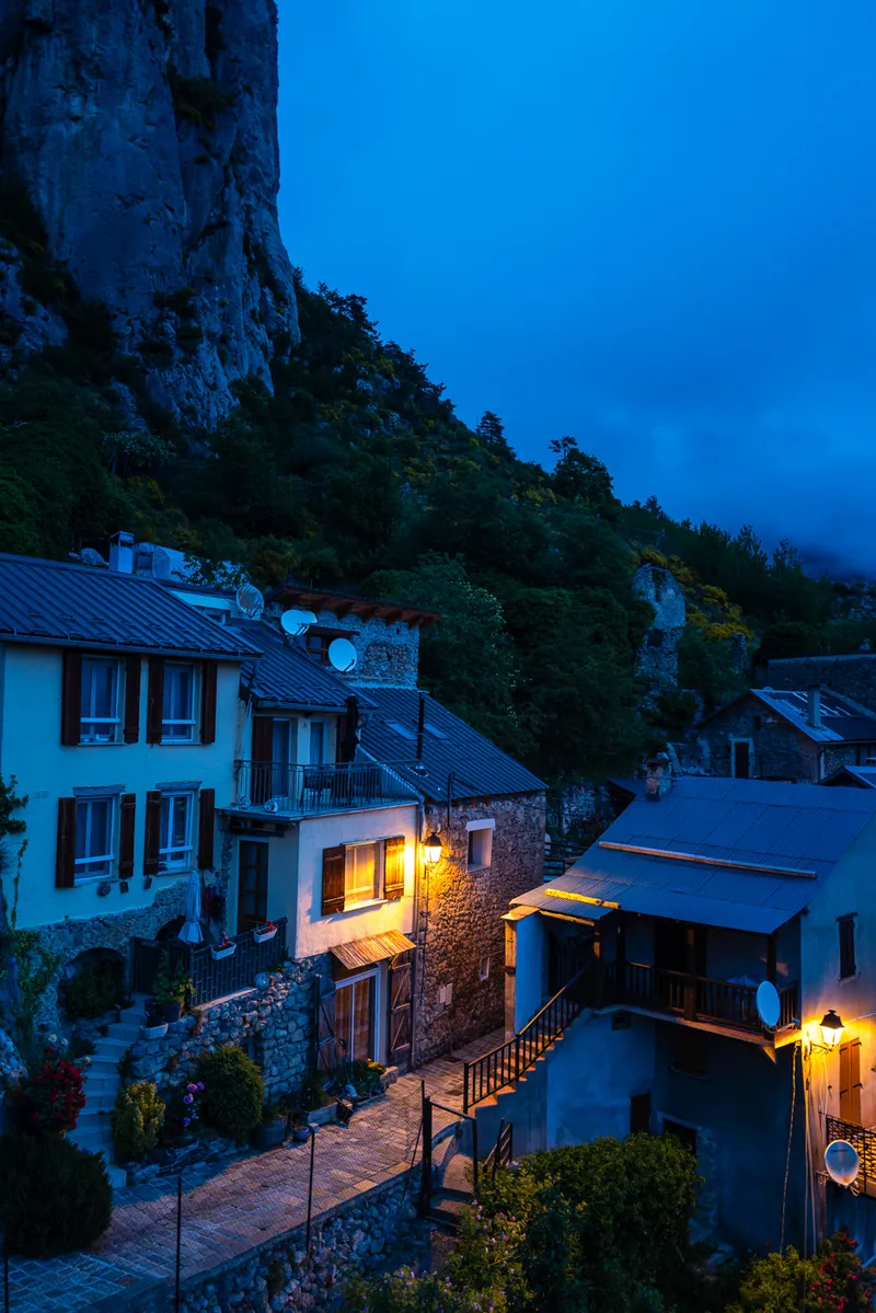Stone walls and lamplight in a Roubion alley at night, Alpes-Maritimes, Leica Q2